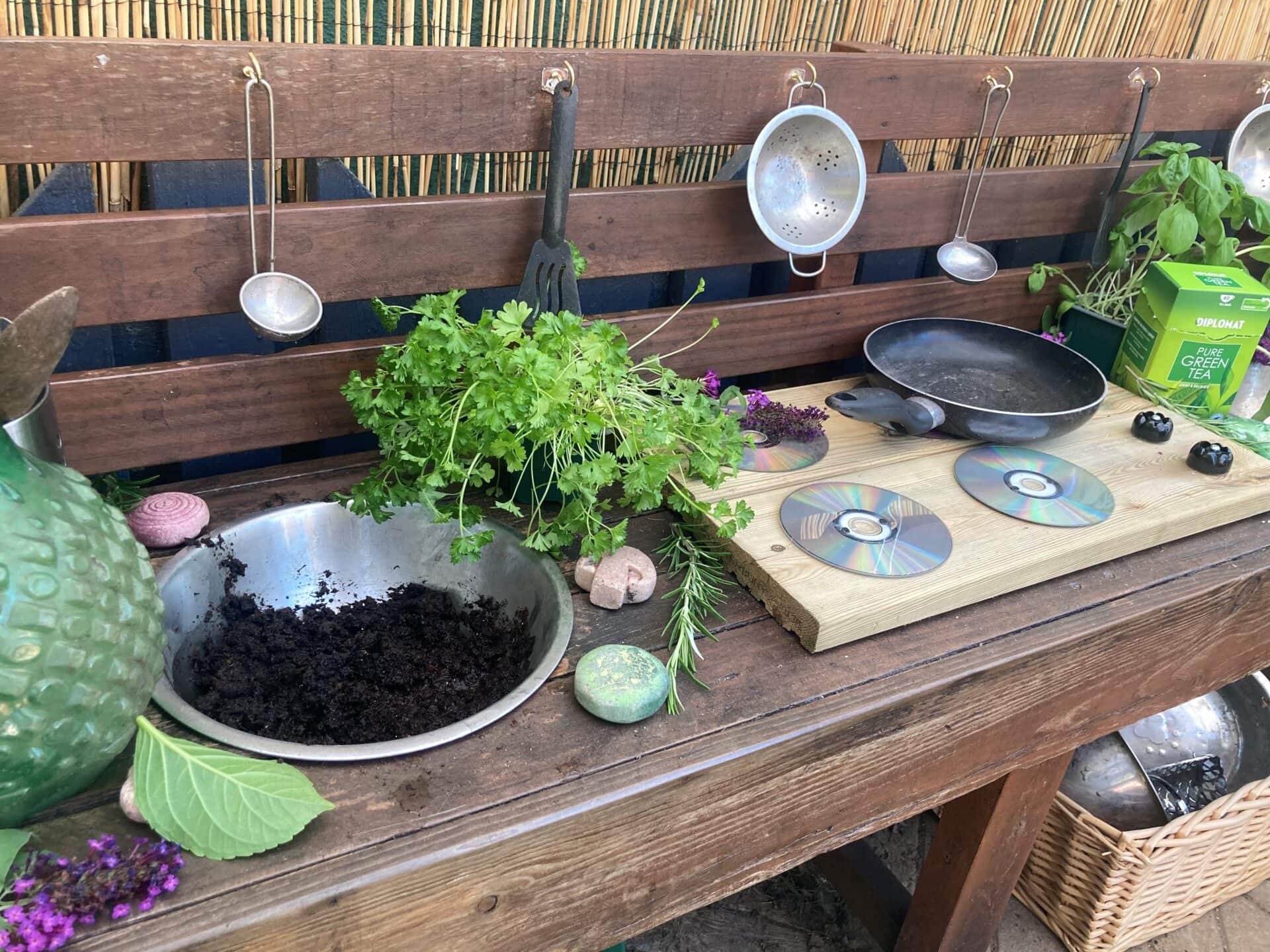 A wooden table with pots and pans on it.